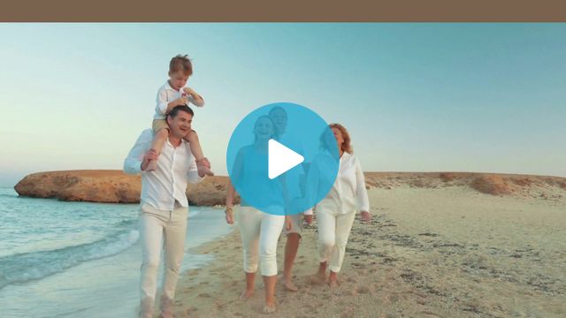 Steadicam shot of happy barefoot family walking along the coast. Child sitting on fathers neck and blowing soap bubbles. Carefree time on vacation